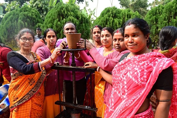 गोमय से गमला बनती हुई महिलाएं